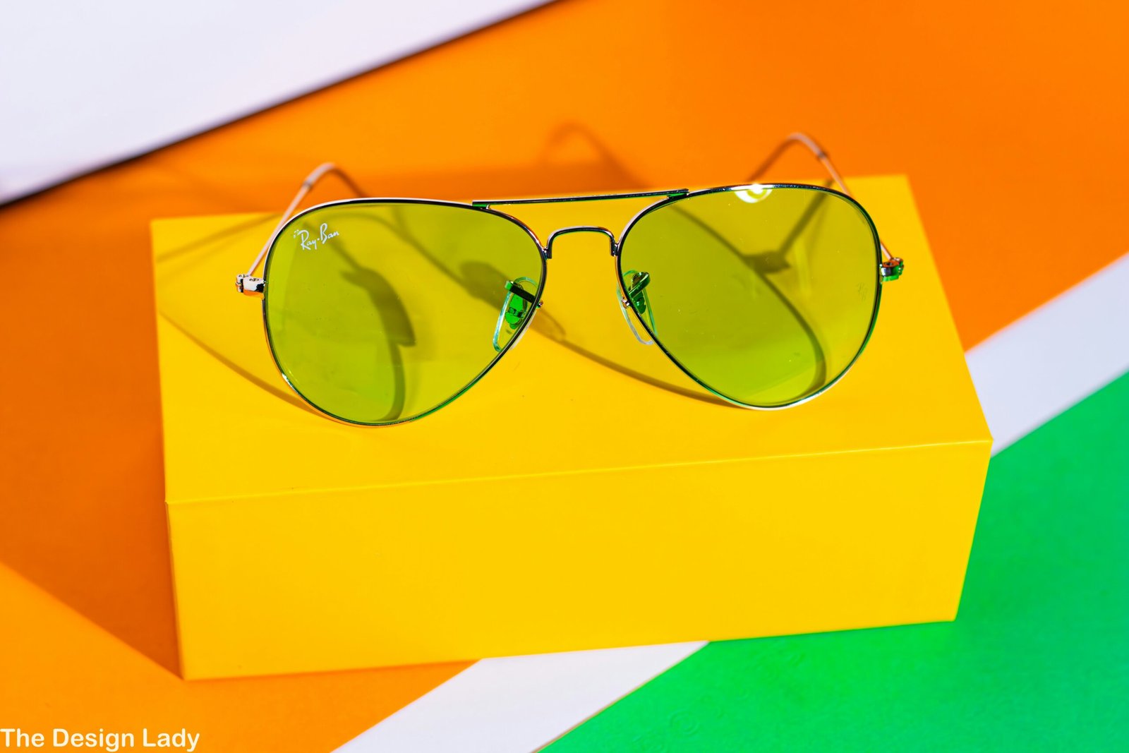 A pair of sunglasses sitting on top of a yellow box